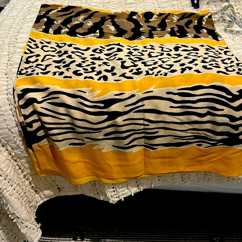 Multi colored scarf/wrap. Yellow/Brown/Black/Cream colors. Excellent condition.